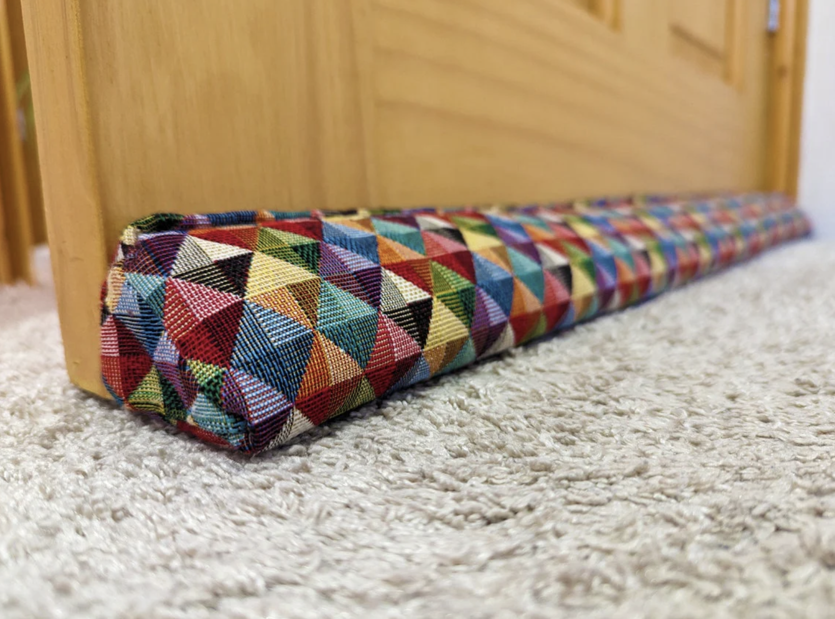 Attach triangular draught excluders to the bottom of your doors..from draughtycrafts.com You can fill them yourself or buy filled and weighted. 100cm width draught excluder costs from £33.80 Attach triangular draught excluders to the bottom of your doors